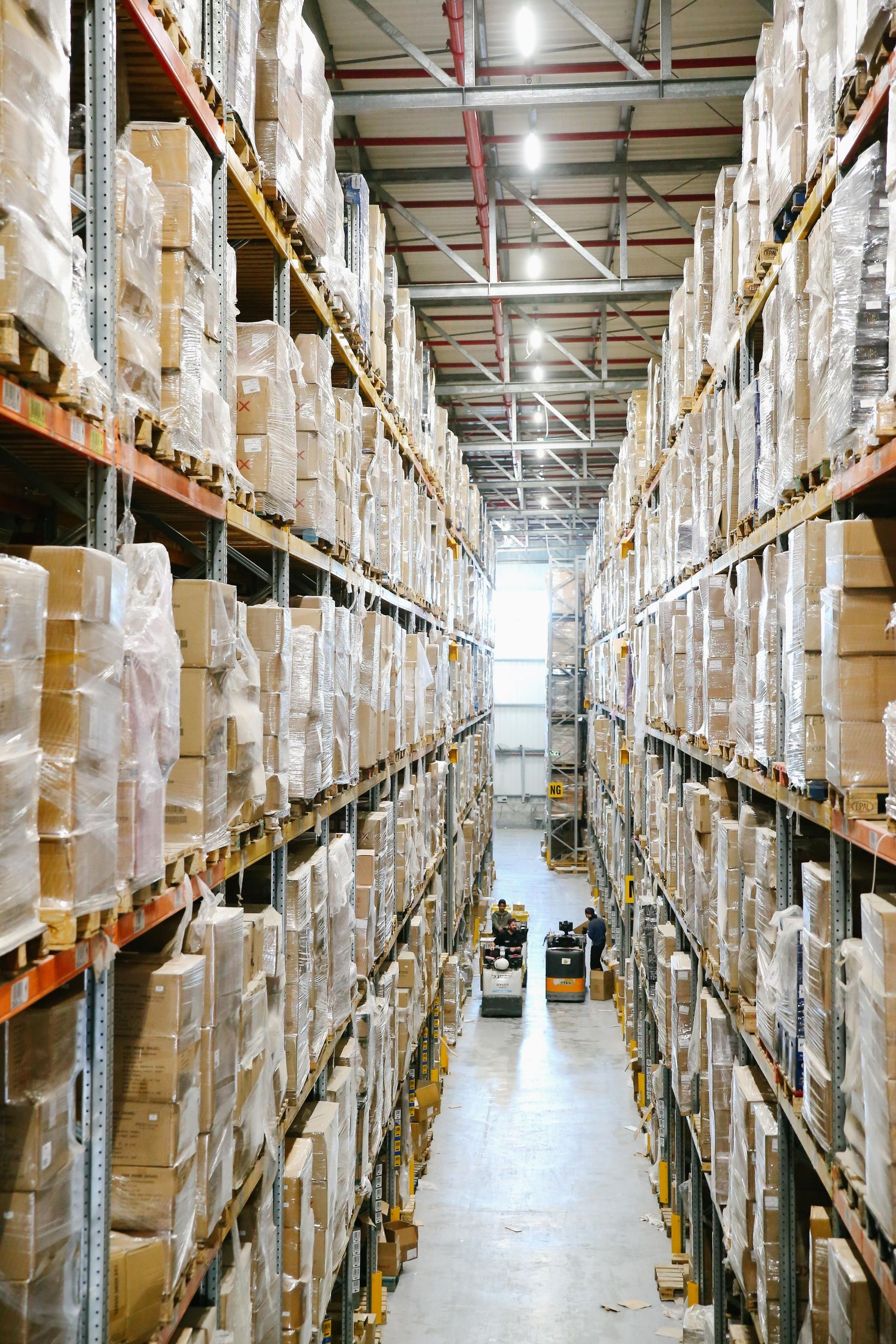 Long warehouse aisle with cartons on tall storage racks
