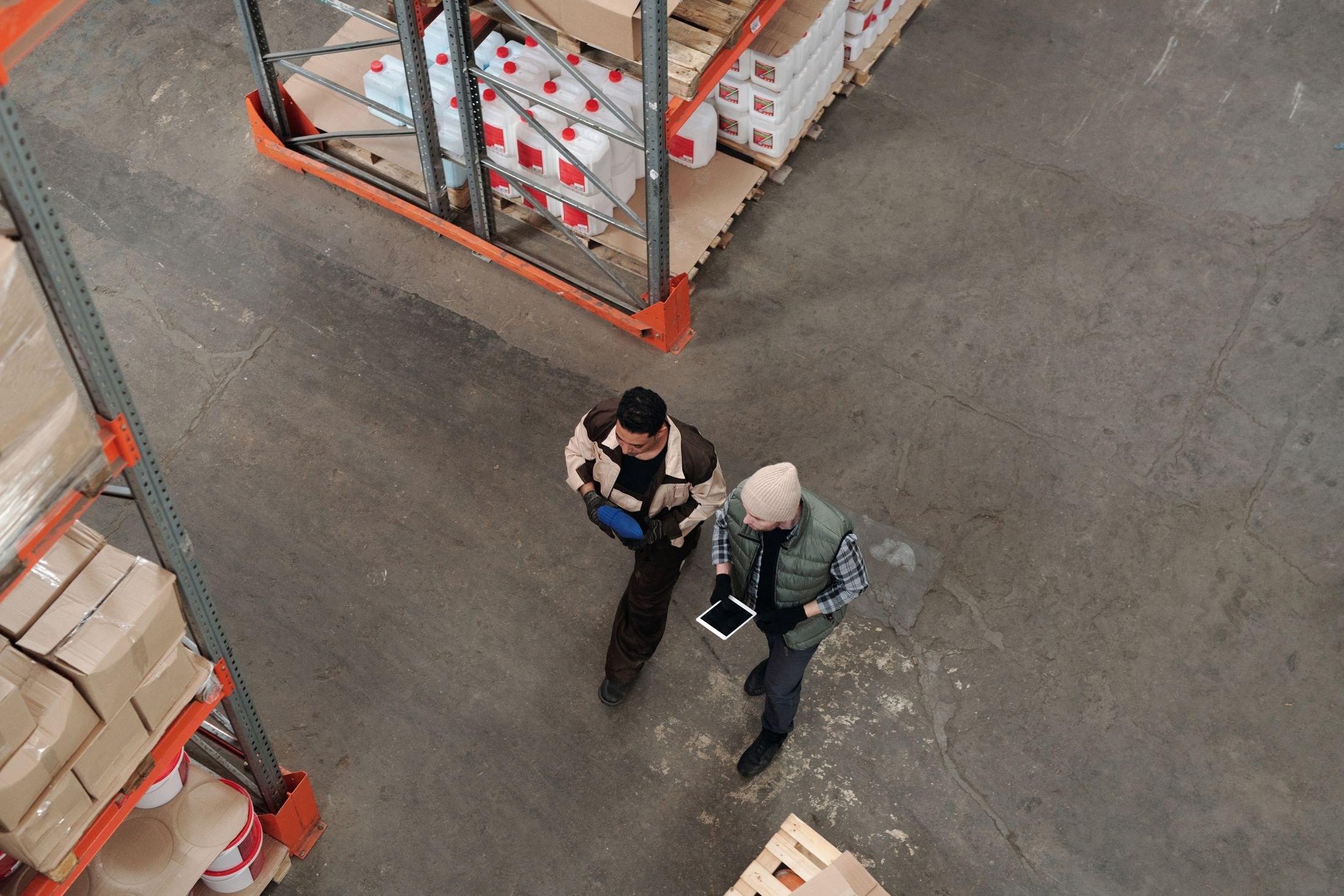 Two warehouse workers reviewing a tablet together
